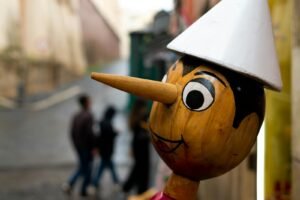 a wooden statue with a white hat on top of it